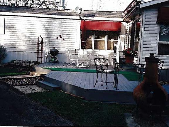 Deck at side yard by garage
						:
						The deck has a retractable awning for shaded comfort all summer long