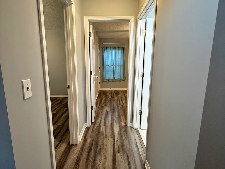 Hallway leading into Bedrooms 2&3 as well as bath