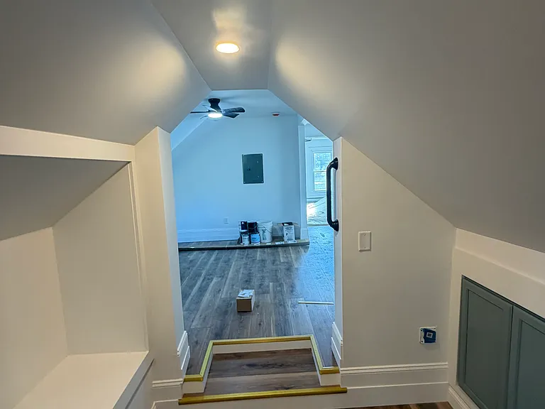 Grand entrance. On the left is a bench to take off your foot wear. On the right are more storage cabinets.