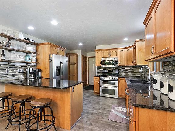 Bright and sunny kitchen with granite counters and breakfast bar.