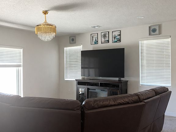 Spacious downstairs living room with abundant natural light.