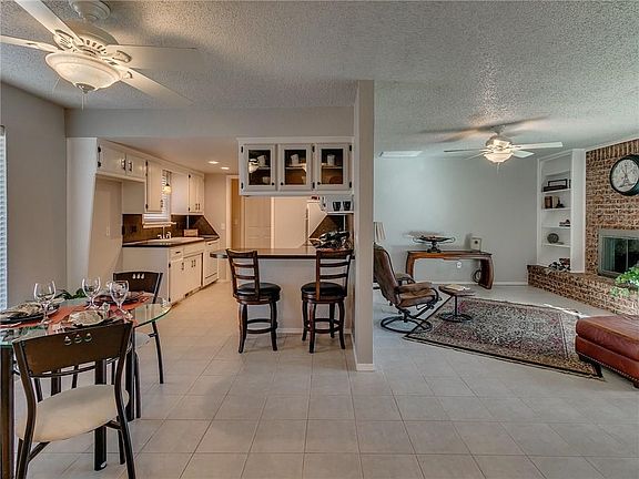 A breakfast bar sports a nice display area for dishes.  The wide open spaces give everyone room to roam.