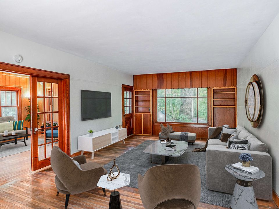 Spacious living room dark wood floors and large windows