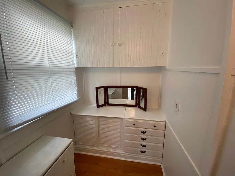The walk-in closet vanity, upper cabinets, drawers, and window