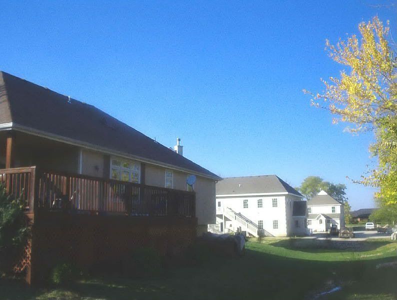 Backyard partially fenced + rock creek!