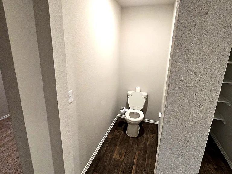 Clean and modern primary bathroom with ample space and storage.