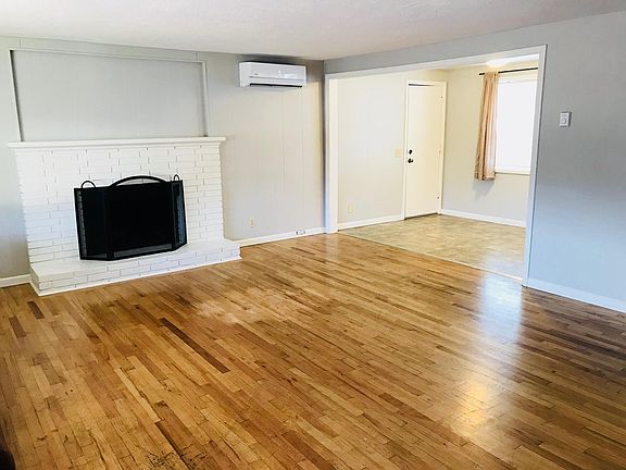 living room with heat/ac, that leads into kitchen dining room