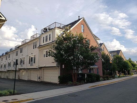 Two car garage and roofdeck visible from the back of the house.