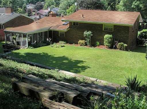 Screened porch with view of beautiful yard.