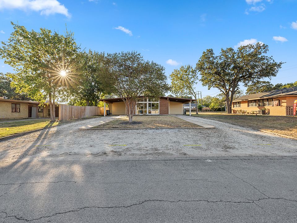Front of the Duplex, Covered Carport on each side with a long driveway.