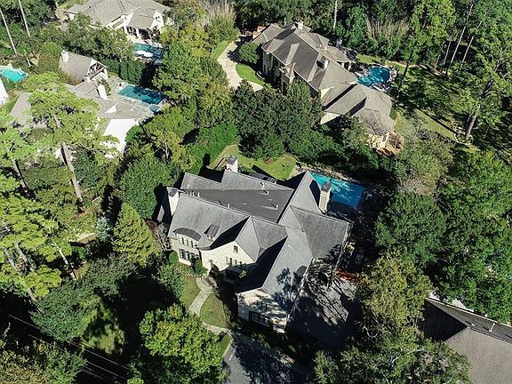 This aerial view shows the mature trees surrounding the home.