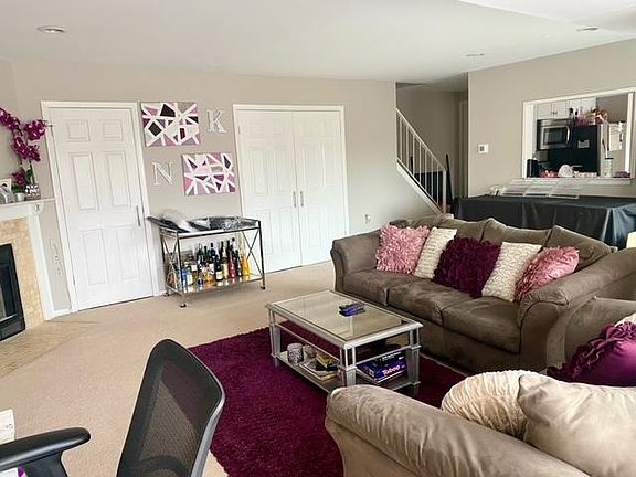 Large living room area with enclosed laundry area