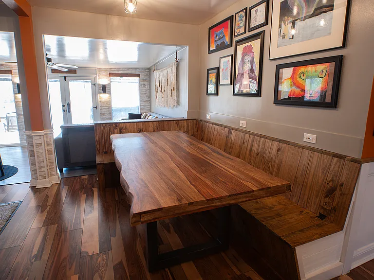 Custom dining bench/table. Bench includes flip-up storage under seat, automatic dustpans (for sweeping - connected to central vac), and USB outlets.