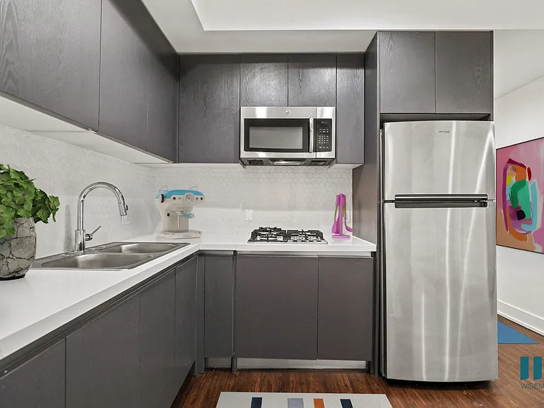 Kitchen with Double-Sink, Refrigerator, Stovetop, and Microwave Oven