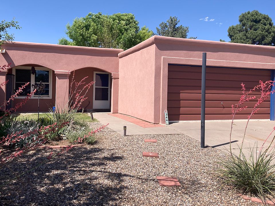 New Mexico casa style with portal, and two car garage. Nice driveway and small manageable garden.