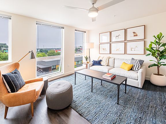 Living Room with Floor to Ceiling Windows, Ceiling Fan, and Spacious Layout