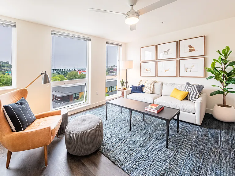 Living Room with Floor to Ceiling Windows, Ceiling Fan, and Spacious Layout