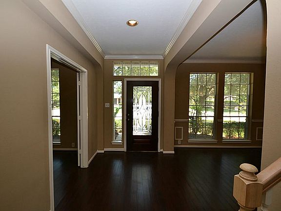 Entry with a beveled glass front door and hardwood floors.