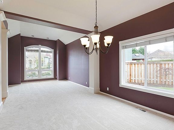 Formal dining room (front) and formal living room (back) with high ceilings