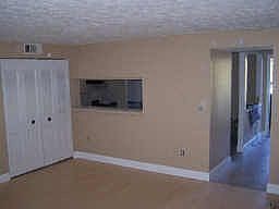 living room has breakfast bar to the kitchen