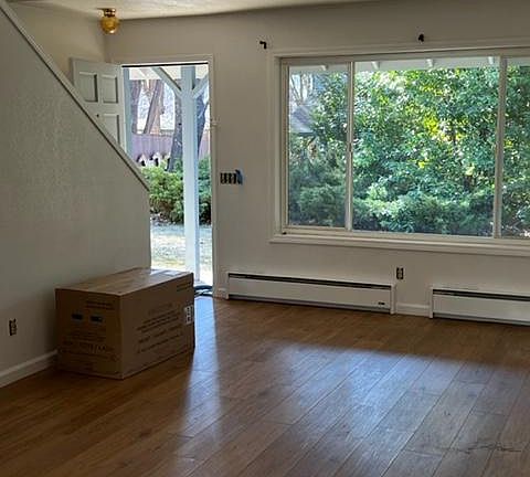 Living room looking out. Stairs on left.