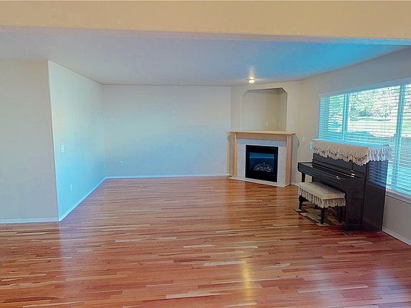 Spacious Family Room featuring a gas fireplace with tile surround and mantle.