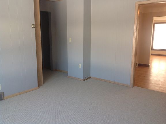 Family room with new carpeting walks out to backyard