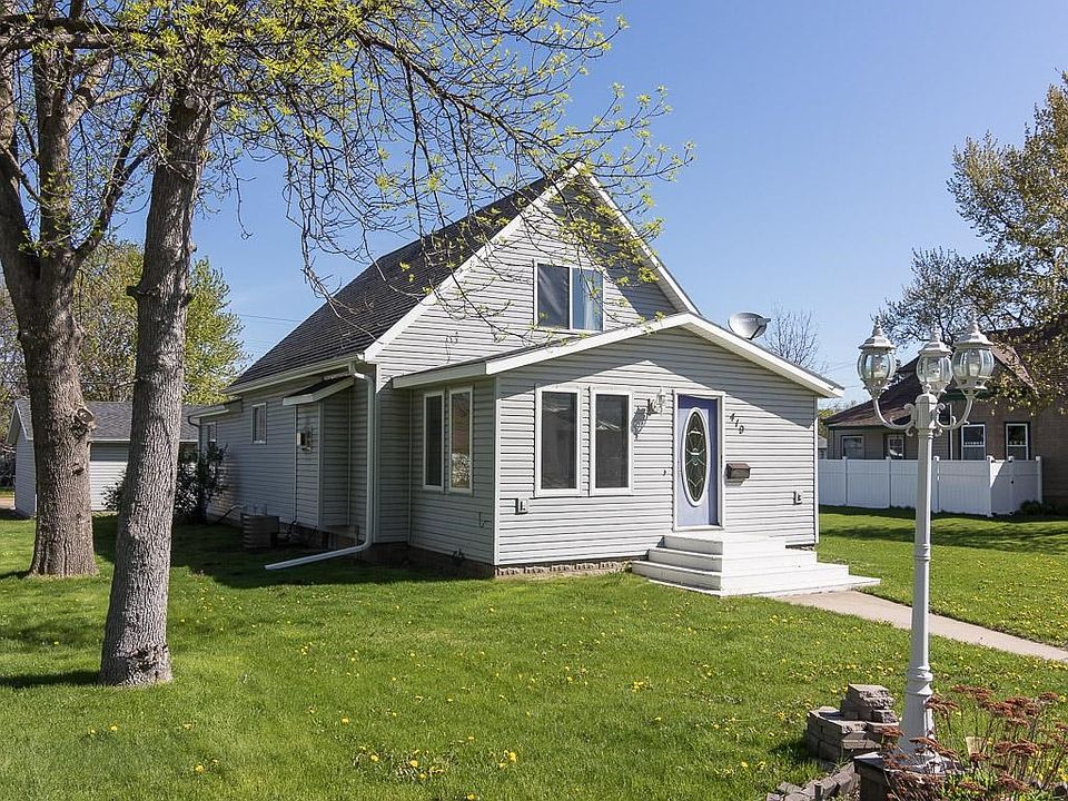 This home has a no maintenance exterior of gray vinyl siding with white trim and gutters.