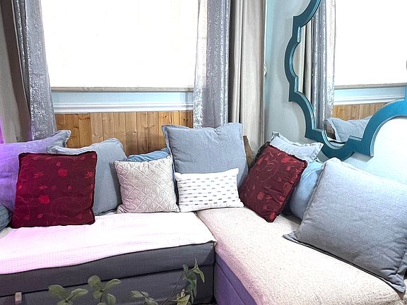 Large relaxing L shaped couch, large window. Large wall mirror here too... to just enlarge this space even larger. Like LA LARGE in things to do!