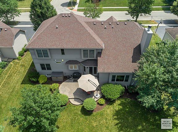 Brick patio and Tree-lined yard.