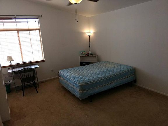 Master bedroom with vaulted ceiling, fan, walk-in closet, do