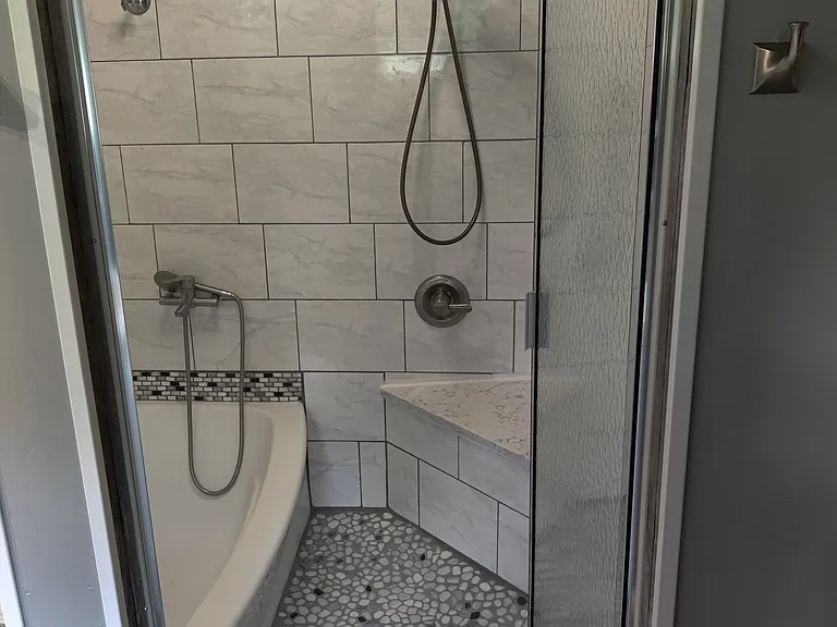 Master Bathroom has 2 individual shower heads, tile walls, custom cieling tiles, with LED light, night light and blue tooth speaker built in, also crown molding trim, rain glass door, backsplash tile trim and custom shower floor.