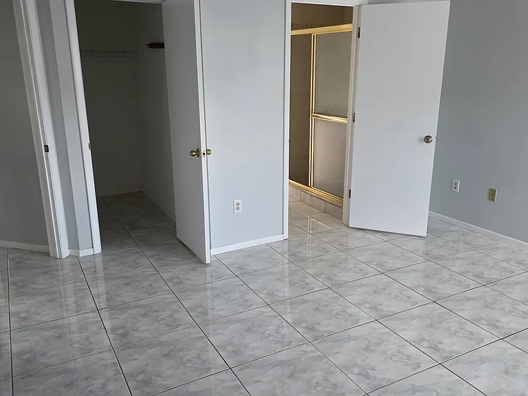 master bedroom showing door entrance (left) master closet(middle) master bathroom entrance(right)