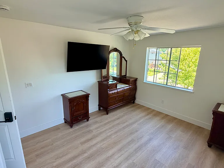 Front Bedroom, w/new 55" Smart TV, Dresser, night stands, Keyless Smart Door Lock, Ceiling Fan, Bed coming Monday. Ready to move in.