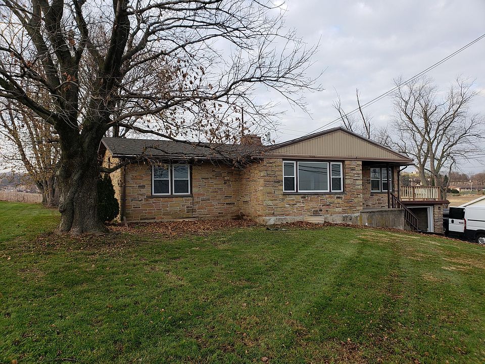 front of home; large patio deck on right, large garage with new insulated garage door & ultra quiet garage door opener