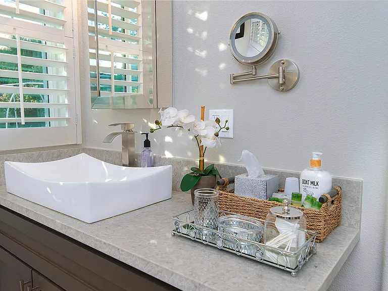 The primary bedroom in room vanity comes equipped with a sink, mounted mirror medicine cabinet and lighted double sided magnifier mirror.