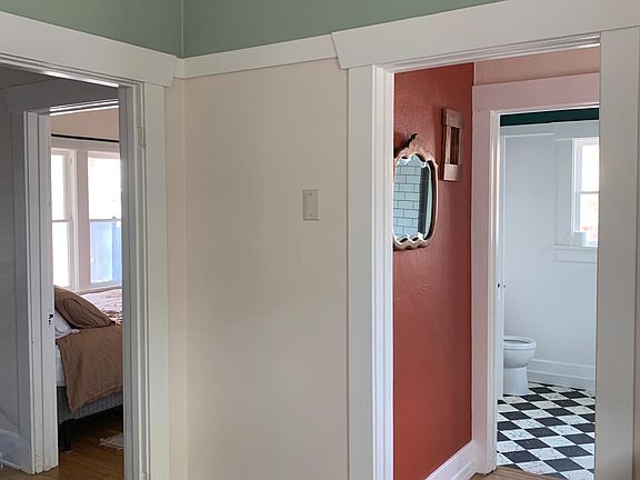 Back hall and entrance to bathroom (R) and bedroom (L) from kitchen