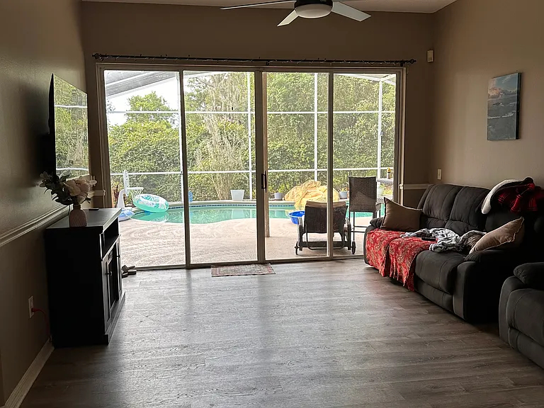 second living room or game room with sliding doors to the pool