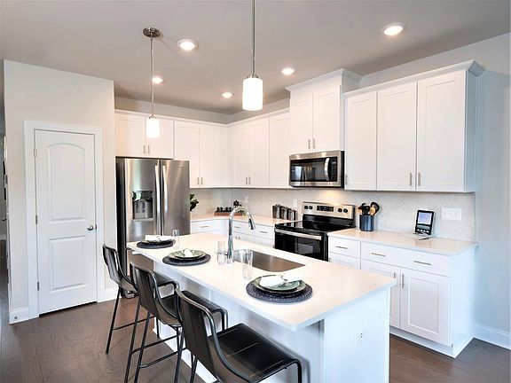 A large kitchen island and plenty of cabinet space makes the at-home-chef feel right at home.