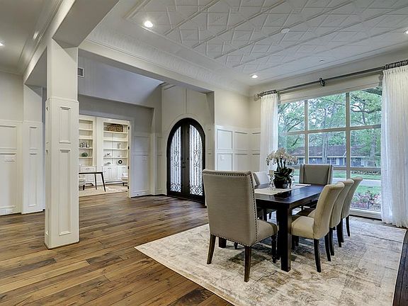 The open floorplan showcases the enormous room sizes, tall ceilings, detailed moldings throughout, and the gorgeous custom Dining Room ceiling molding.
