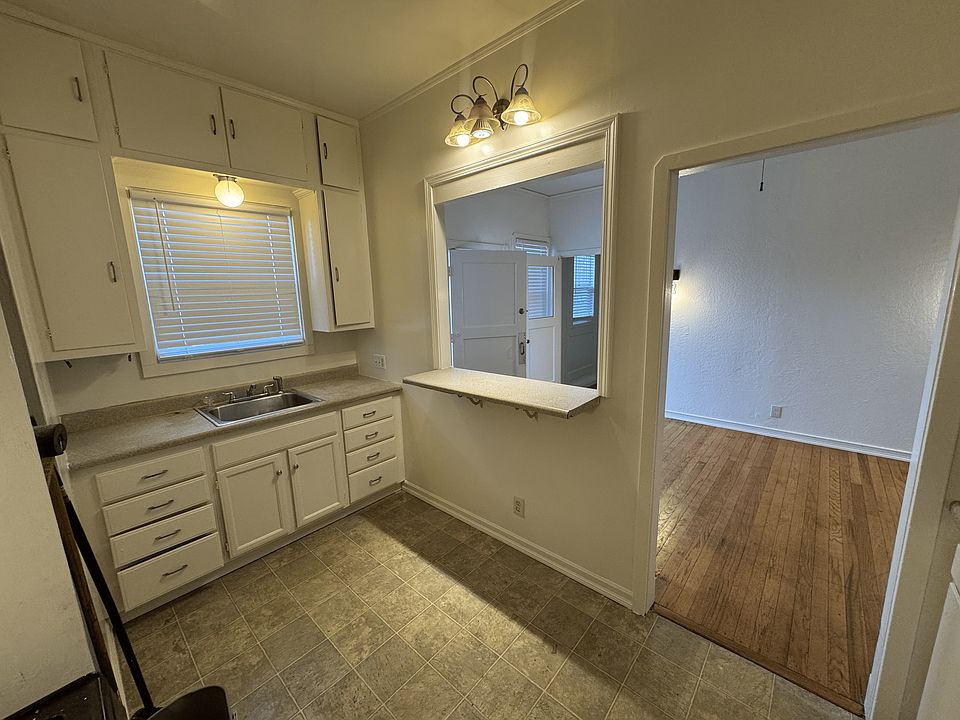 Kitchen with open window to the living room