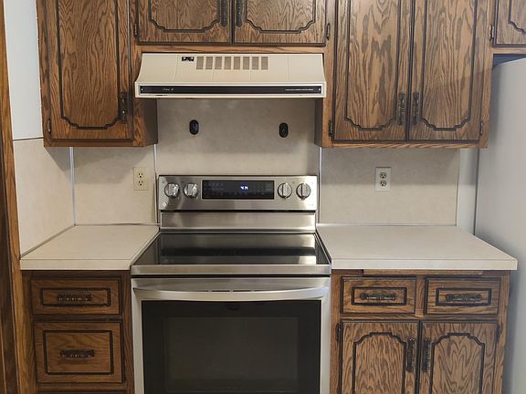 New glass top stainless steel LG convection oven with lots of features. Laundry room to the left.