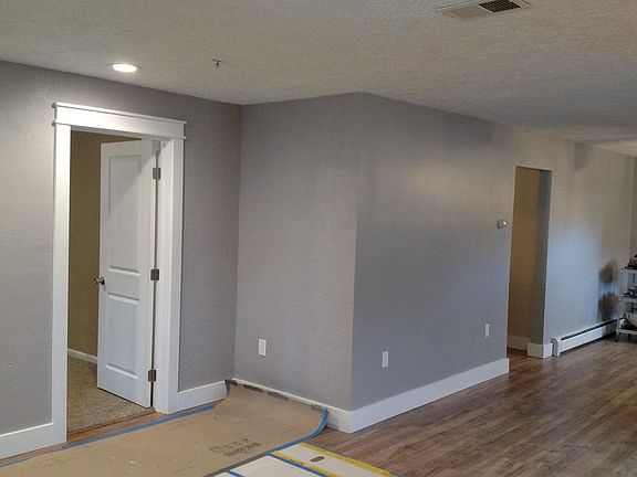 The door to front bedroom is to the left and to the right is the large open kitchen big enough for a portable island or small table.