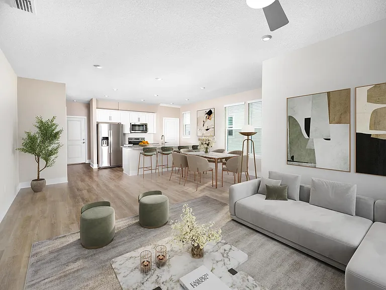 An open, light-filled layout at Amavi Kissimmee offers generous space to gather, with a seamless flow from kitchen to living area and views of your private yard.