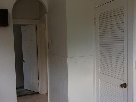 old charm of arched doorways, kitchen has original built in ironing board, telephone niche. Bathroom has laundry chute to basement