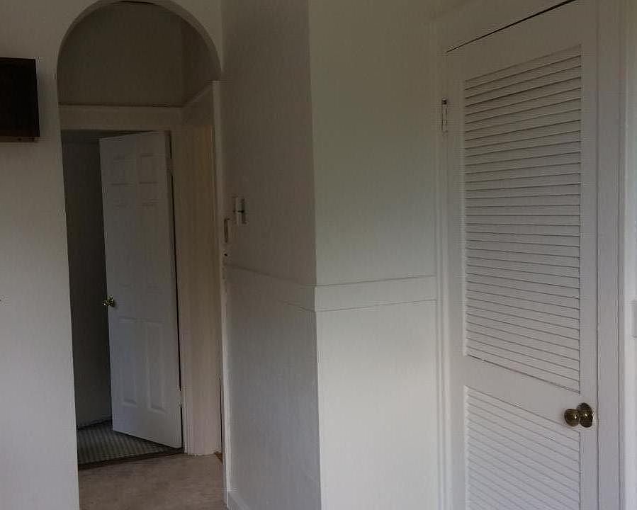 old charm of arched doorways, kitchen has original built in ironing board, telephone niche. Bathroom has laundry chute to basement