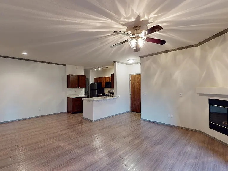 Apartment dining and living room with wood-style flooring.
