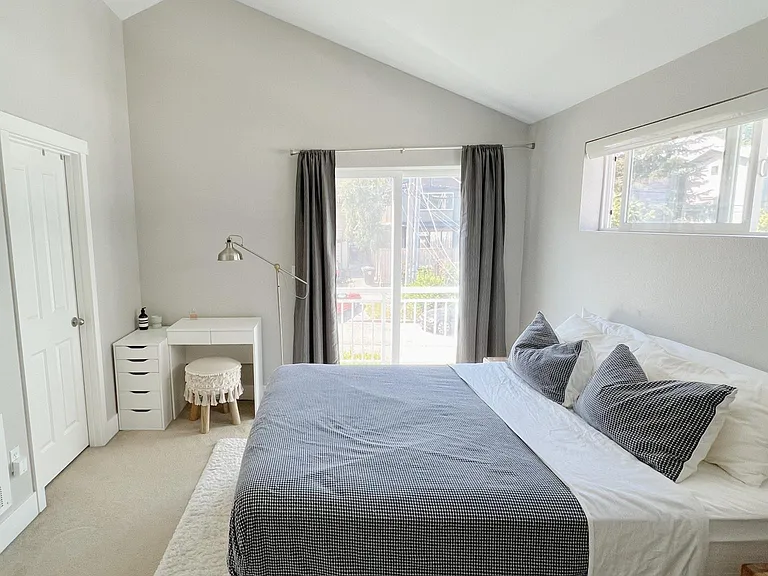Upstairs master suite with sun-drenched balcony overlooking street