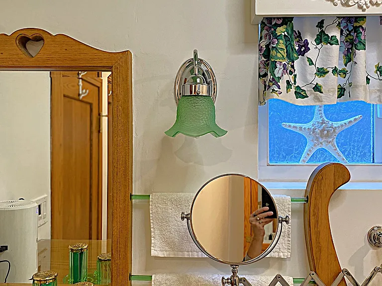 Studio Bathroom boasts a Magnified Shaving or Make-up Mirror