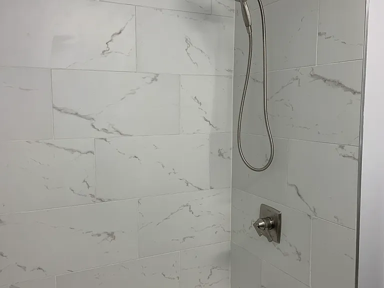 Bathroom with a tub off of the hallway and shared by two of the bedrooms.